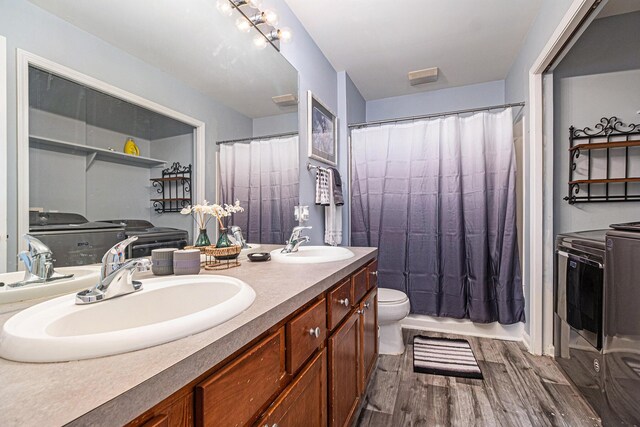6650 Wing St, Ypsilanti, MI 48197 - bathroom with wood finished floors, double vanity, and washer and clothes dryer