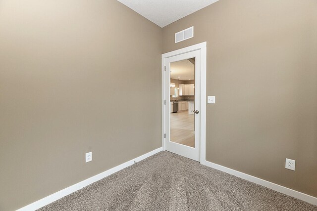 unfurnished room with carpet flooring