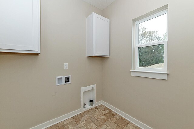 laundry area with cabinets, hookup for an electric dryer, and hookup for a washing machine