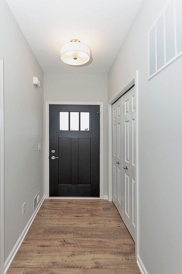 entryway with hardwood / wood-style flooring