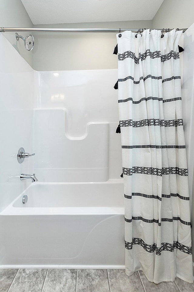 bathroom with tile patterned flooring and shower / tub combo with curtain