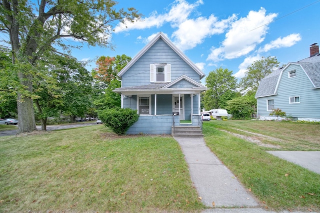 bungalow featuring a front lawn and covered porch