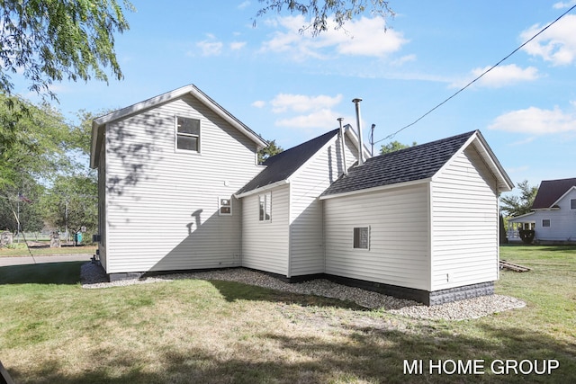 rear view of house with a yard