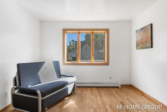 sitting room featuring hardwood / wood-style floors and a baseboard radiator