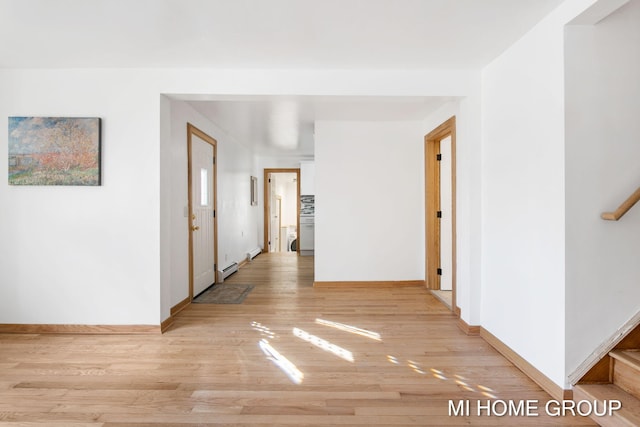 corridor featuring light hardwood / wood-style floors and a baseboard heating unit