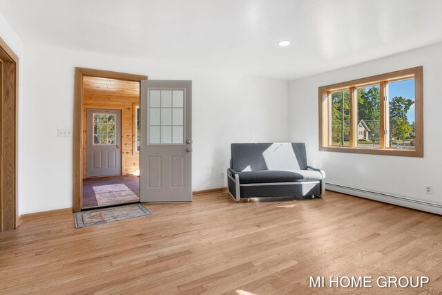 sitting room with light hardwood / wood-style floors and a baseboard radiator