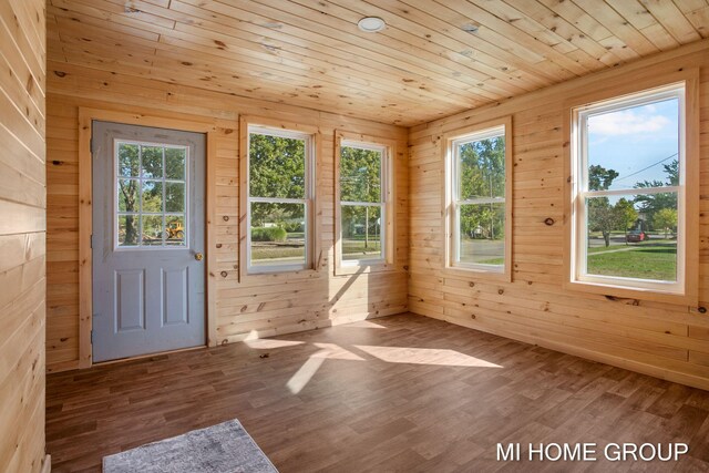 unfurnished sunroom with a healthy amount of sunlight and wood ceiling