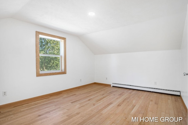 bonus room with a baseboard radiator, lofted ceiling, and light wood-type flooring