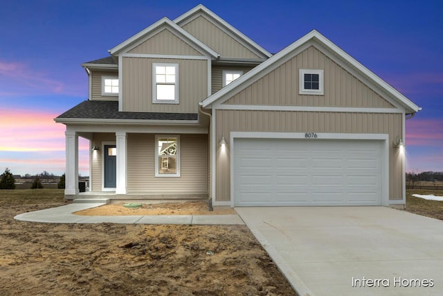 view of front of house with a garage, covered porch, roof with shingles, and driveway