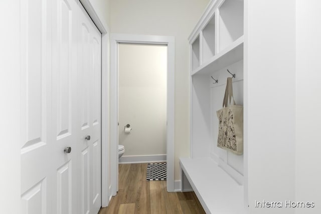 mudroom featuring baseboards and wood finished floors