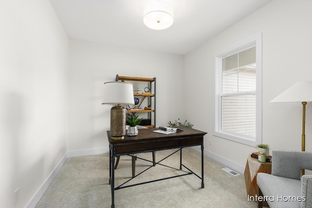 carpeted office space featuring visible vents and baseboards