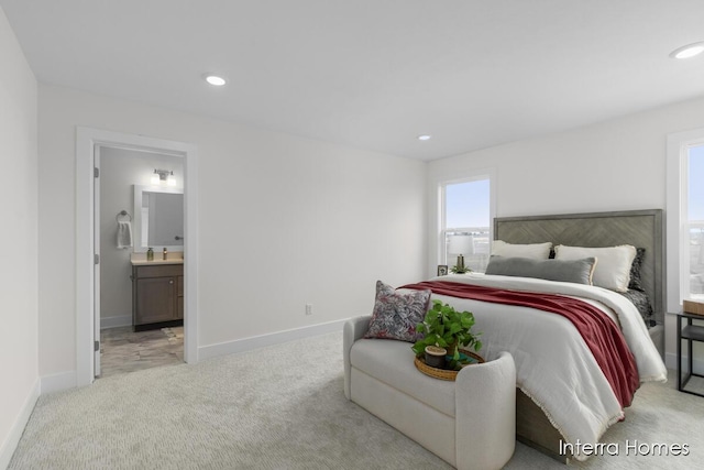 bedroom with light carpet, baseboards, a sink, and recessed lighting