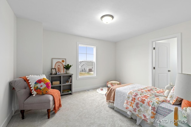 bedroom with carpet floors, visible vents, and baseboards