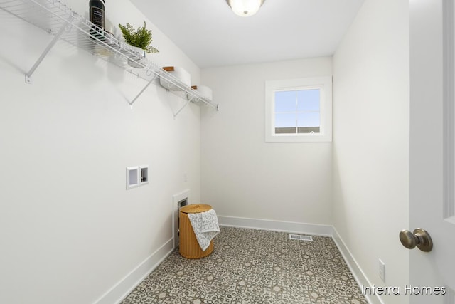 laundry room featuring hookup for a washing machine, laundry area, visible vents, and baseboards