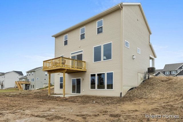 rear view of property featuring a deck and central air condition unit