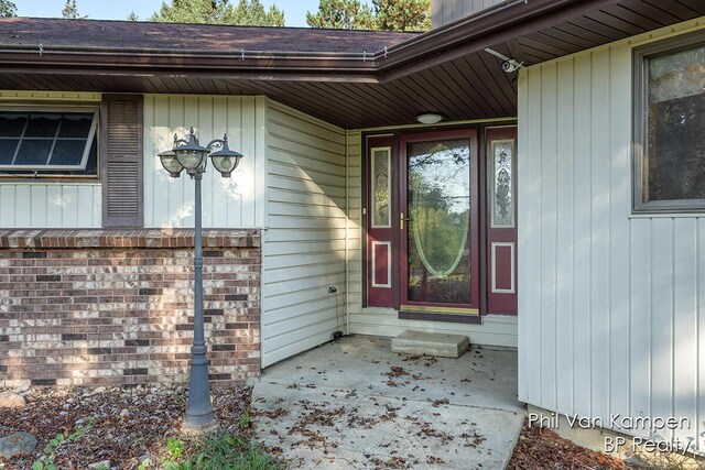 entrance to property featuring brick siding