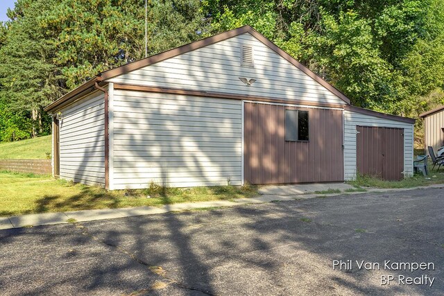 exterior space with an outbuilding and a garage
