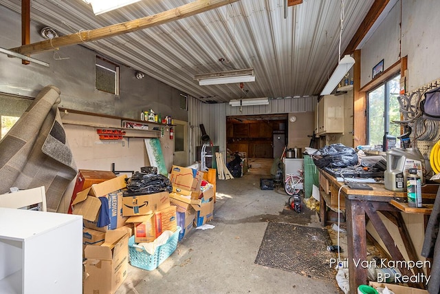 miscellaneous room featuring unfinished concrete flooring and a workshop area