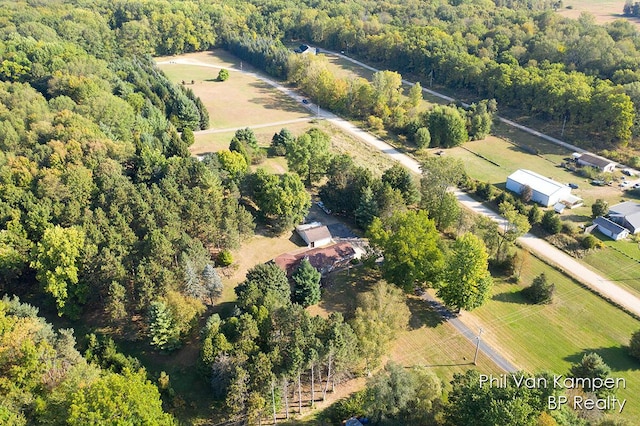 bird's eye view featuring a wooded view and a rural view