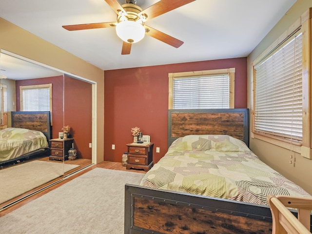 bedroom featuring a closet, multiple windows, and ceiling fan