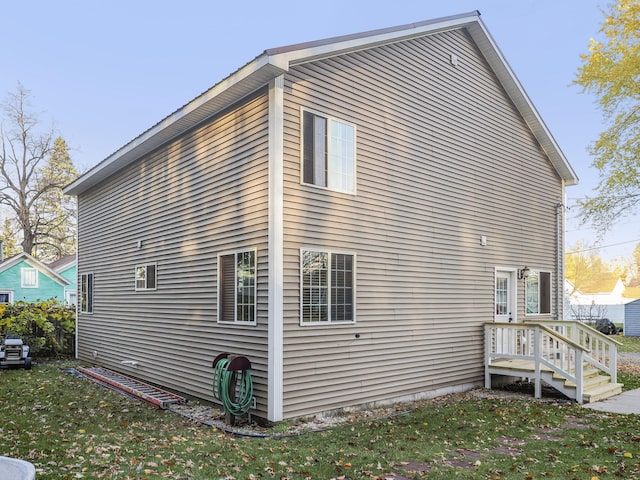 view of property exterior with a yard