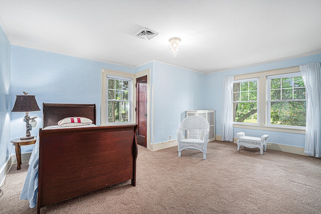 carpeted bedroom featuring crown molding