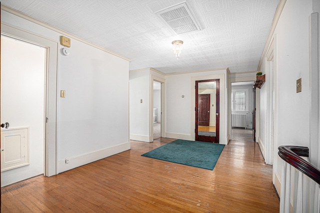 foyer with radiator and light hardwood / wood-style floors