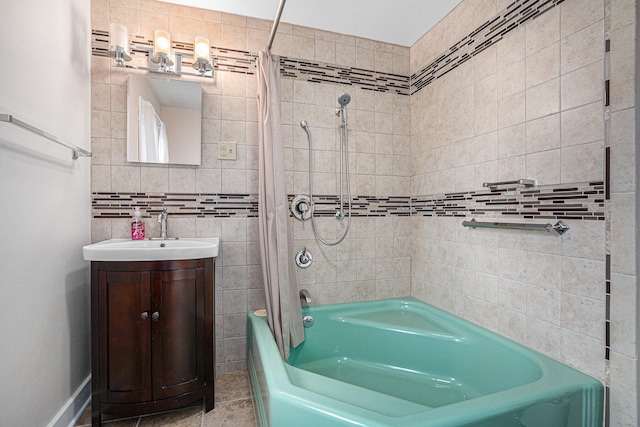 bathroom featuring tile walls, vanity, shower / bath combo with shower curtain, and tile patterned floors