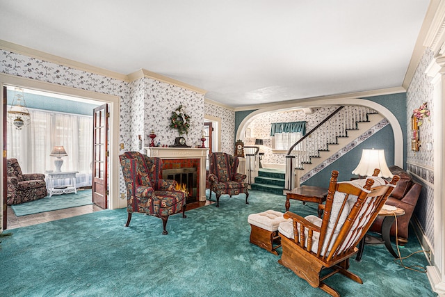 living area with ornamental molding and carpet