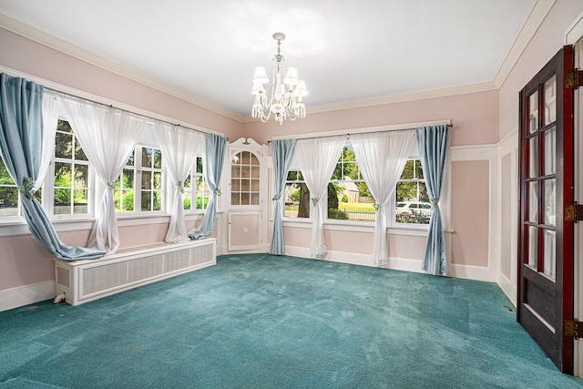 interior space featuring a notable chandelier, plenty of natural light, dark colored carpet, and crown molding