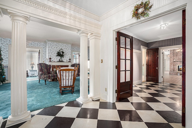 entrance foyer with a fireplace and decorative columns