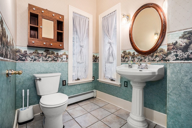 bathroom with tile patterned flooring, toilet, and a baseboard heating unit