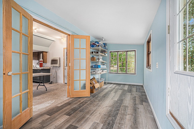 foyer entrance featuring vaulted ceiling, french doors, and hardwood / wood-style flooring