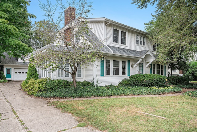 front of property featuring a garage and a front yard