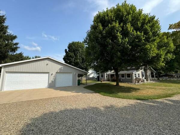 view of front of property with a front lawn and a garage