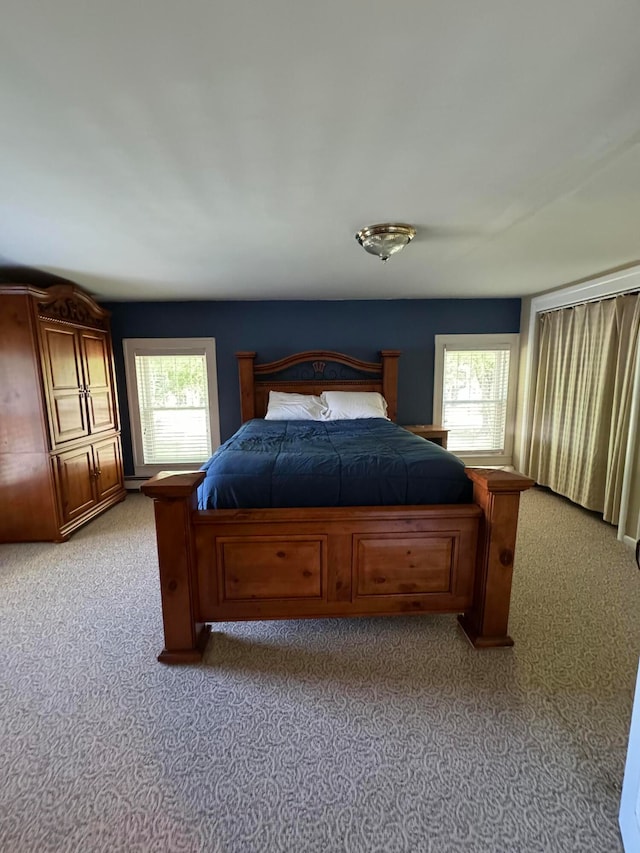 bedroom featuring light carpet and multiple windows