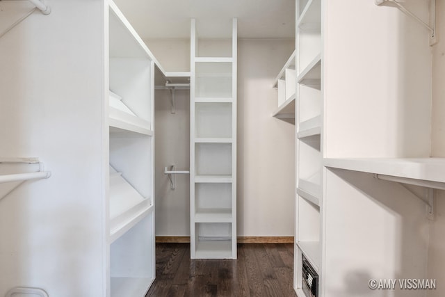 walk in closet featuring dark hardwood / wood-style floors