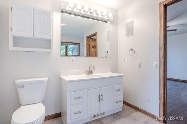 bathroom featuring wood-type flooring, vanity, and toilet