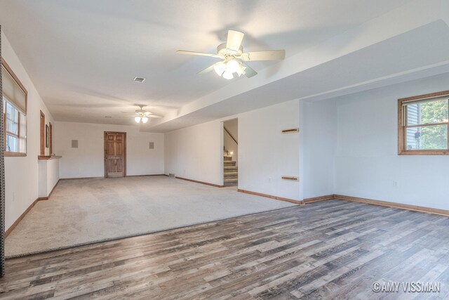 unfurnished room with hardwood / wood-style floors, ceiling fan, and plenty of natural light