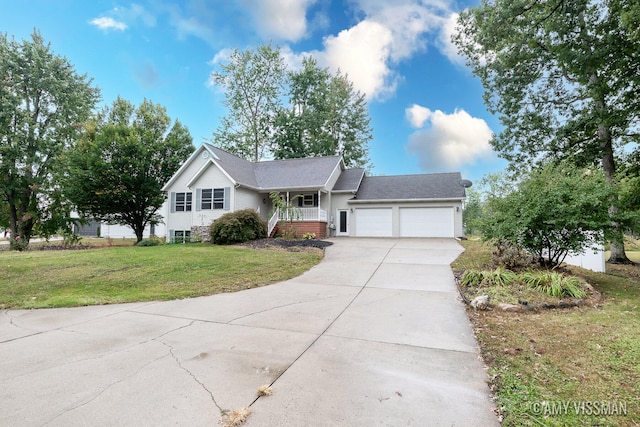 view of front of home featuring a garage, a front lawn, and covered porch