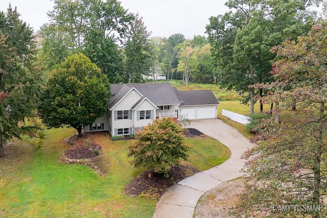 view of front of home with a garage and a front yard