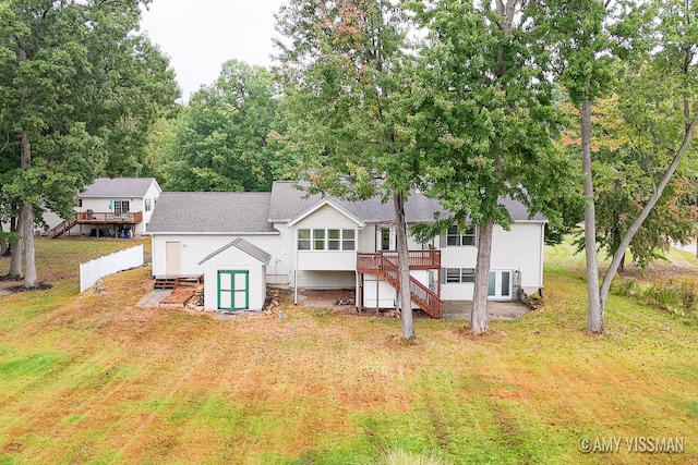 back of house featuring central AC, a yard, and a wooden deck