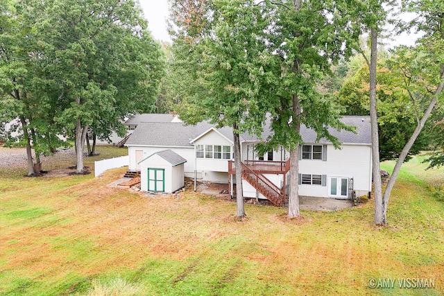 rear view of house featuring a deck and a yard