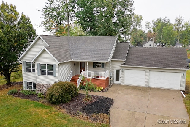 view of front facade featuring a porch and a garage