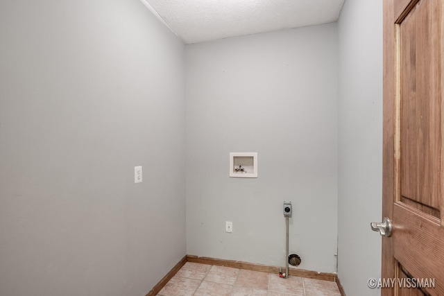 clothes washing area featuring hookup for a washing machine, a textured ceiling, and electric dryer hookup