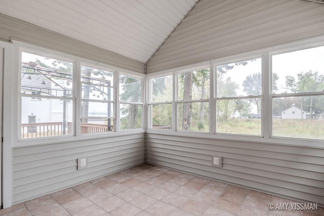 unfurnished sunroom featuring wood ceiling, vaulted ceiling, and a wealth of natural light