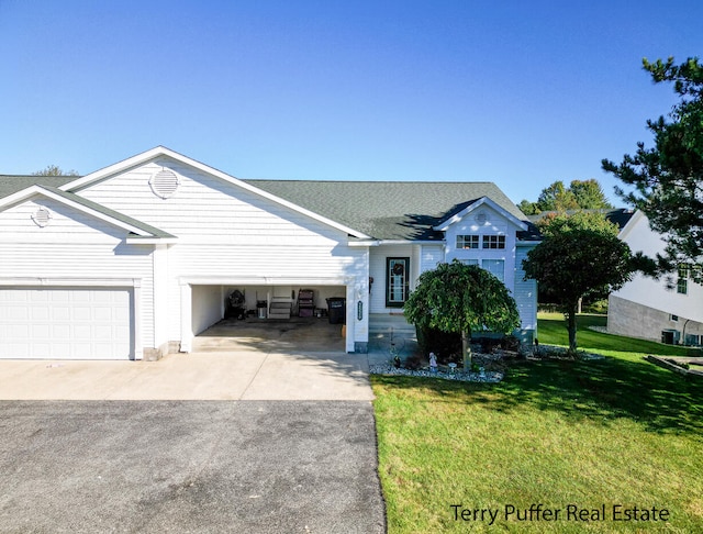 view of front of house with a garage and a front lawn