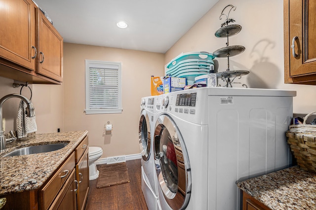 laundry area featuring dark wood-type flooring, sink, and washer and dryer