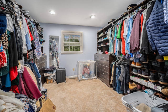 walk in closet with carpet