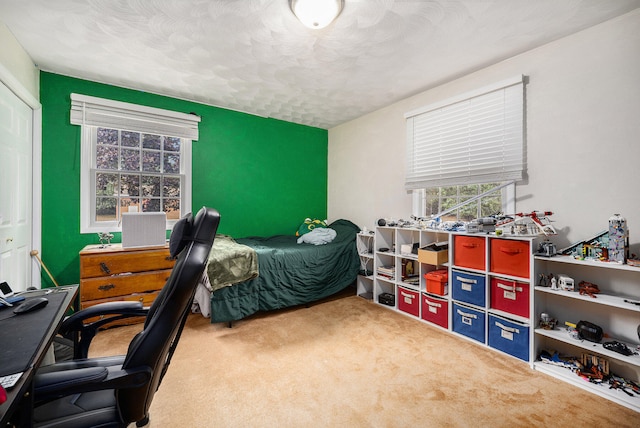 bedroom featuring a textured ceiling, a closet, and carpet